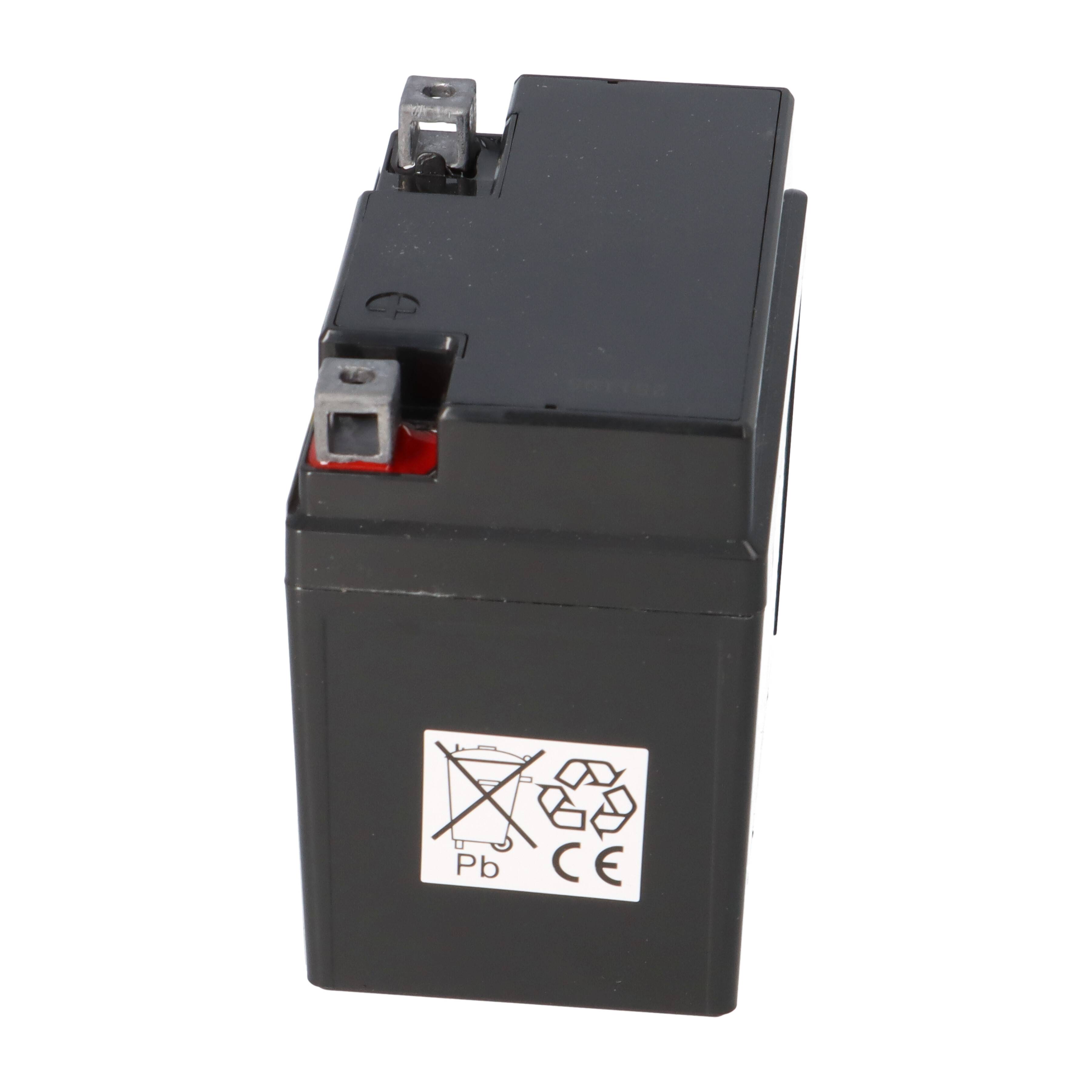 Ein rechteckiger schwarzer Akku mit Anschlussanschlüssen oben. Die Seite zeigt Recycling- und Gefahrensymbole, die auf Bleigehalt hinweisen.