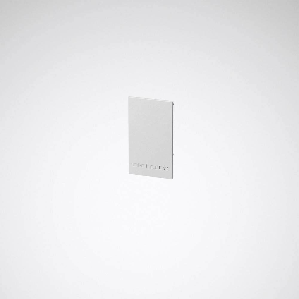 Ein minimalistischer weißer Lichtschalter mit modernem Design vor einem schlichten grauen Hintergrund.