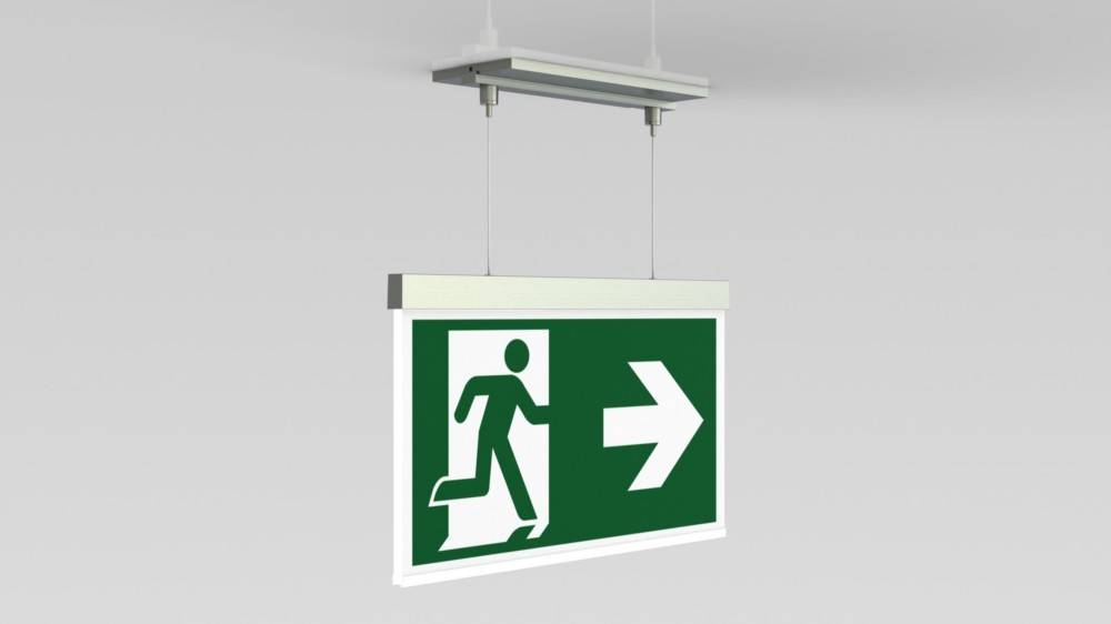 Ein hängender grüner Notausgangsschild mit einer Figur, die durch eine Tür läuft, gefolgt von einem nach rechts weisenden Pfeil.