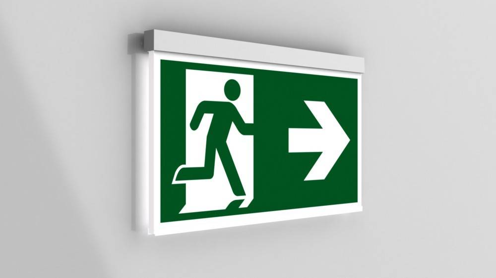 Ein Notausgangsschild, das eine Person zeigt, die auf eine Tür zuläuft, mit einem nach rechts weisenden Pfeil, der die Richtung zum Ausgang angibt.