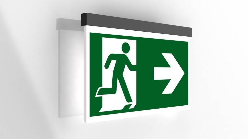 Grünes Notausgangsschild mit einer laufenden Person, die auf einen nach rechts weisenden Pfeil zuläuft und die Richtung zum Ausgang anzeigt.