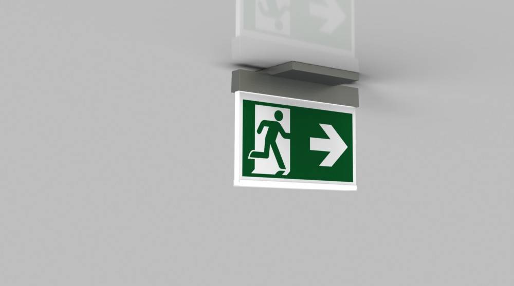 Notausgangsschild mit grünem Hintergrund, das eine weiße Figur zeigt, die nach rechts läuft und die Richtung zum Ausgang angibt.