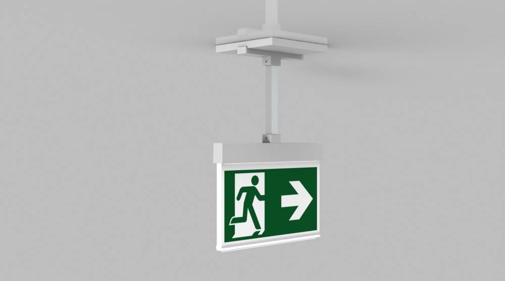 Ein deckenmontiertesNotausgangsschild mit grünem Hintergrund, das eine laufende Person und einen nach rechts weisenden Pfeil zeigt und die Fluchtrichtung angibt.