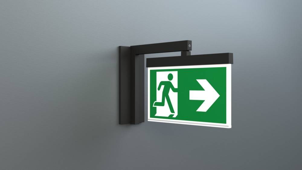 Notausgang-Schild mit einer laufenden Figur und einem Pfeil, der nach rechts weist und die Richtung zur Sicherheit anzeigt.