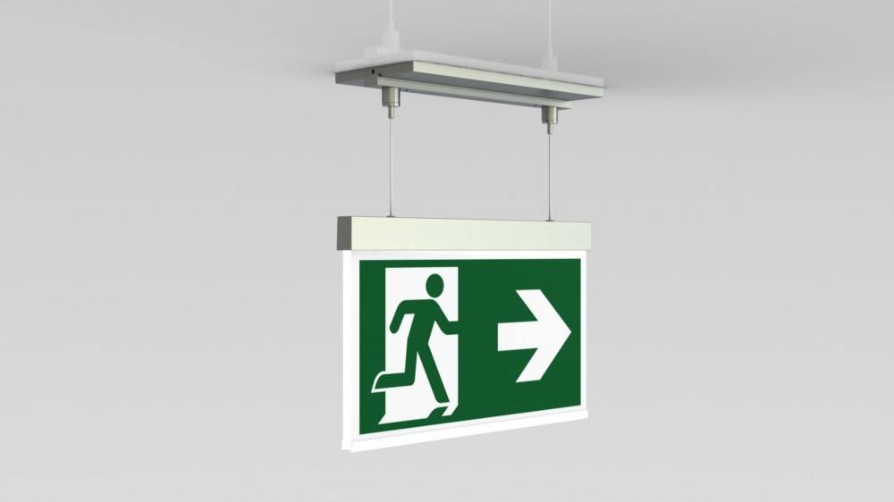 Ein an der Decke montiertes Notausgangsschild mit grünem Hintergrund, das eine weiße Figur zeigt, die sich nach rechts bewegt und auf einen nach rechts weisenden Pfeil zusteuert.