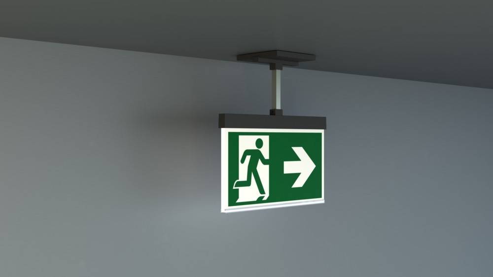 Fluchtwegeschild mit einer Figur, die nach rechts läuft und die Richtung des Notausgangs anzeigt.