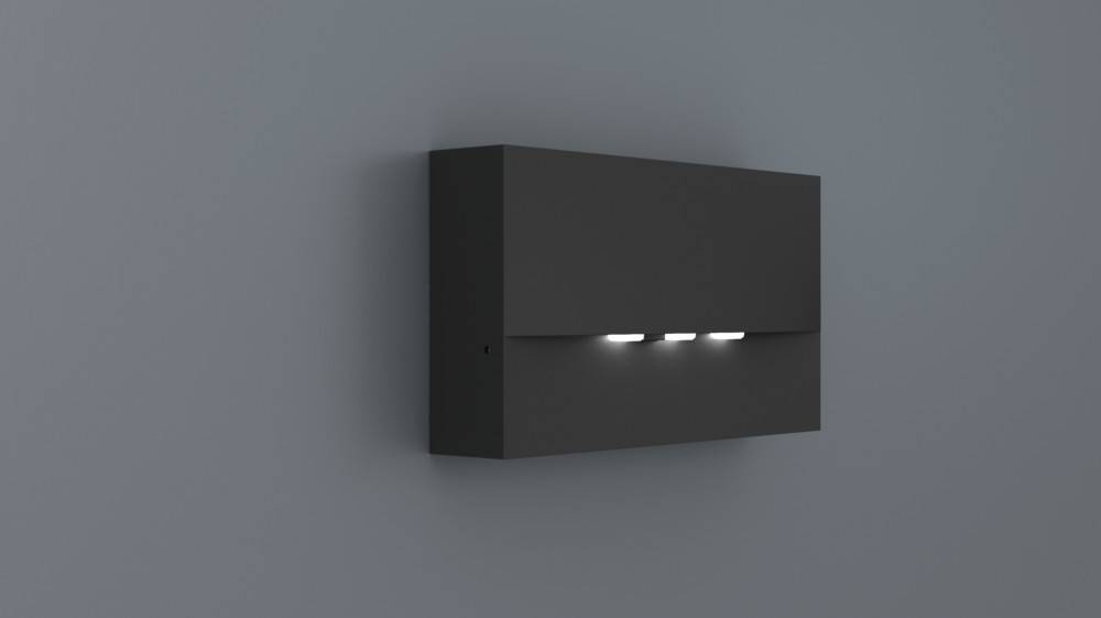 Ein schlankes, rechteckiges dunkles Wandlicht mit drei Lichtstrahl, die aus kleinen Öffnungen am unteren Ende austreten und an einer grauen Wand montiert sind.