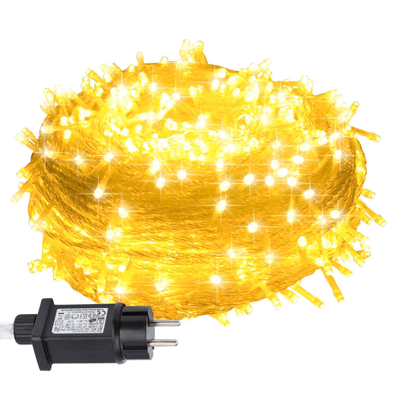 Batteriebetriebene Lichterketten in warmem Gelb leuchtend, dargestellt mit dem schwarzen Steckeradapter darunter.