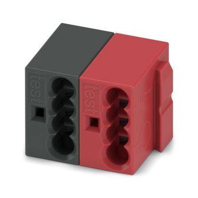 Ein Paar Testblöcke, einer grau und einer rot, mit verzahntem Design. Jeder Block hat verschiedene geformte Löcher zum Testen von Verbindungen.