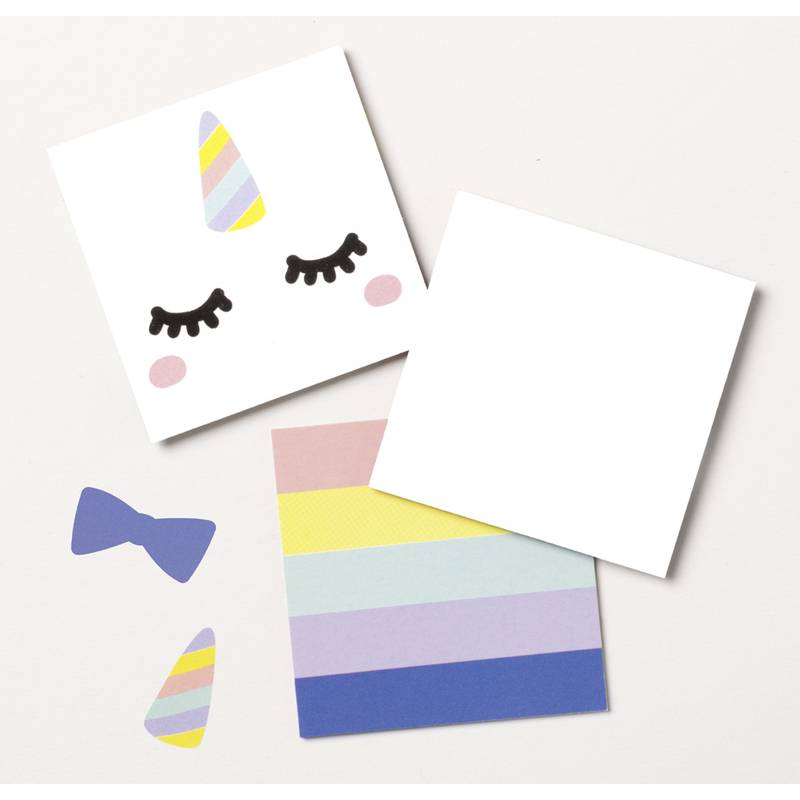 Ein Set bunter Schreibwaren umfasst eine Karte mit einem Einhorn-Gesichts-Design, eine regenbogengestreifte Karte, eine leere Karte und dekorative Ausschnitte.