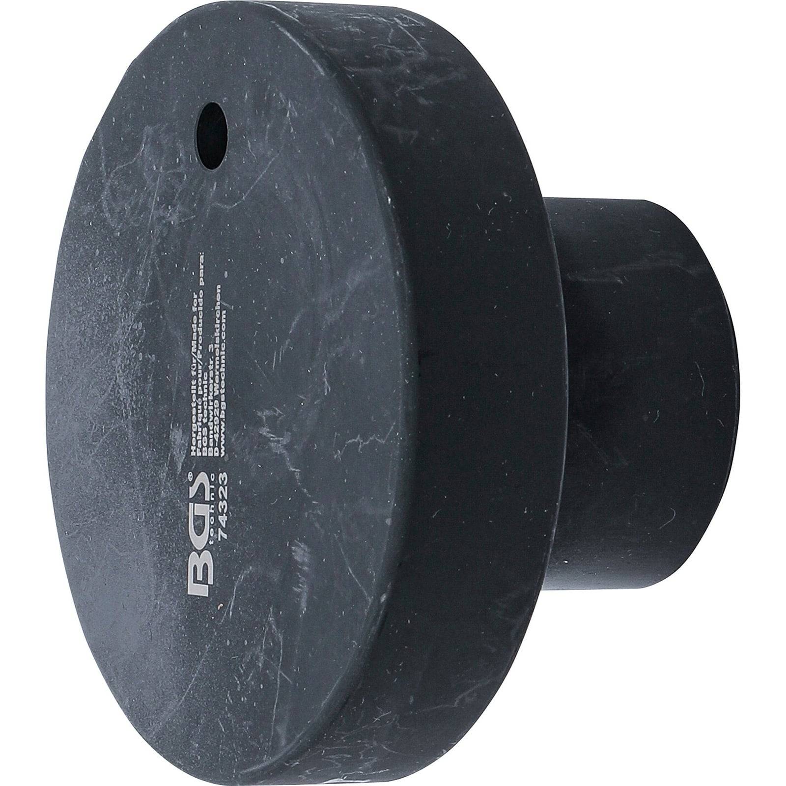 Eine schwarze Gummidrivetrain-Stütze mit einer flachen kreisförmigen Basis und einer kurzen zylindrischen Verlängerung.