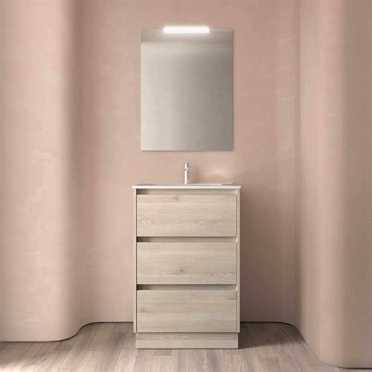 Modernes Badezimmer-Waschtisch mit dreierschubladenschrank, Waschbecken und beleuchtetem Spiegel an weichen beigefarbenen Wänden.