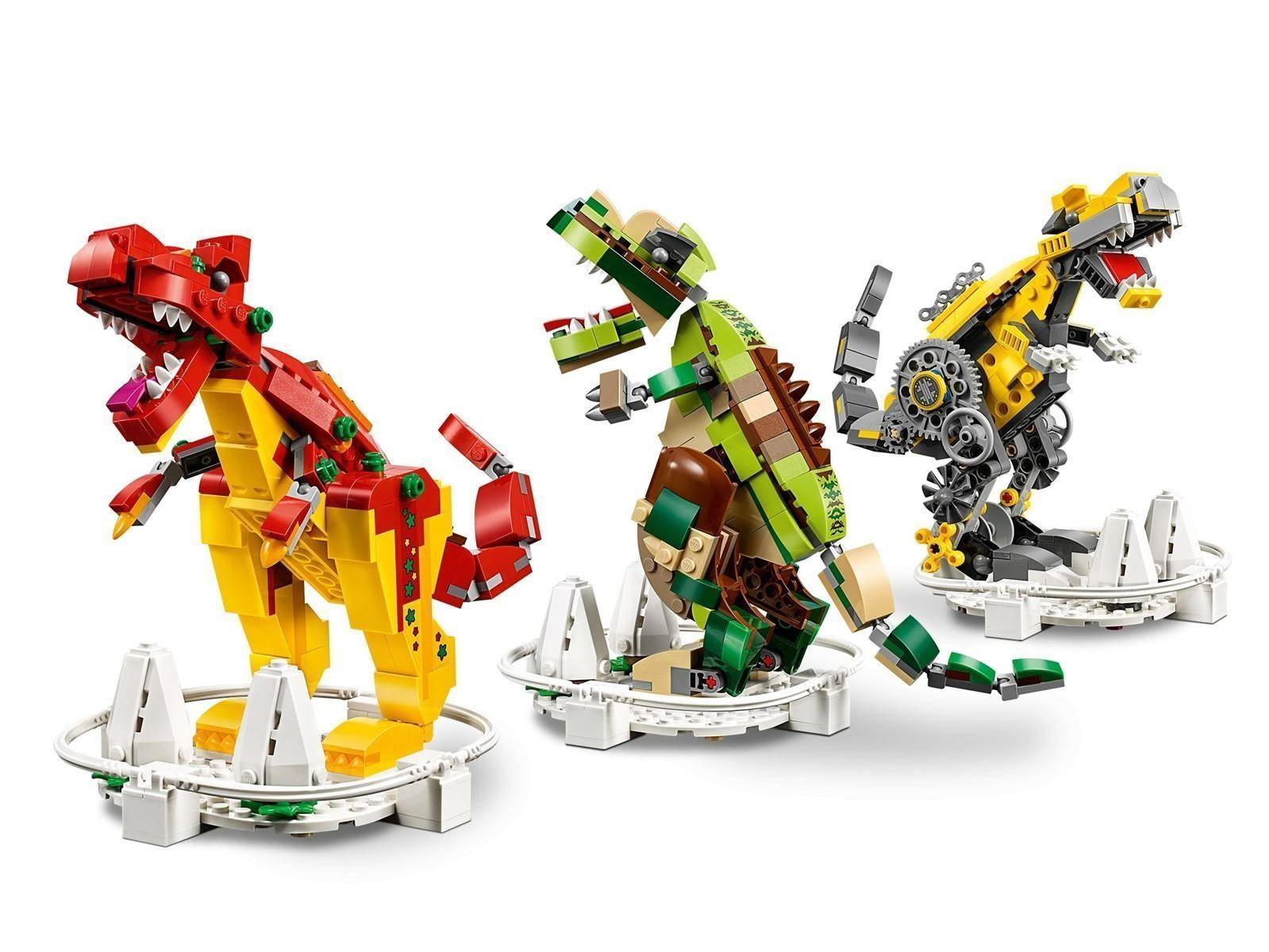 Drei LEGO-Roboter-Dinosaurier-Modelle in Rot, Grün und Gelb stehen auf weißen Ausstellungsbasen vor einem einfachen Hintergrund.