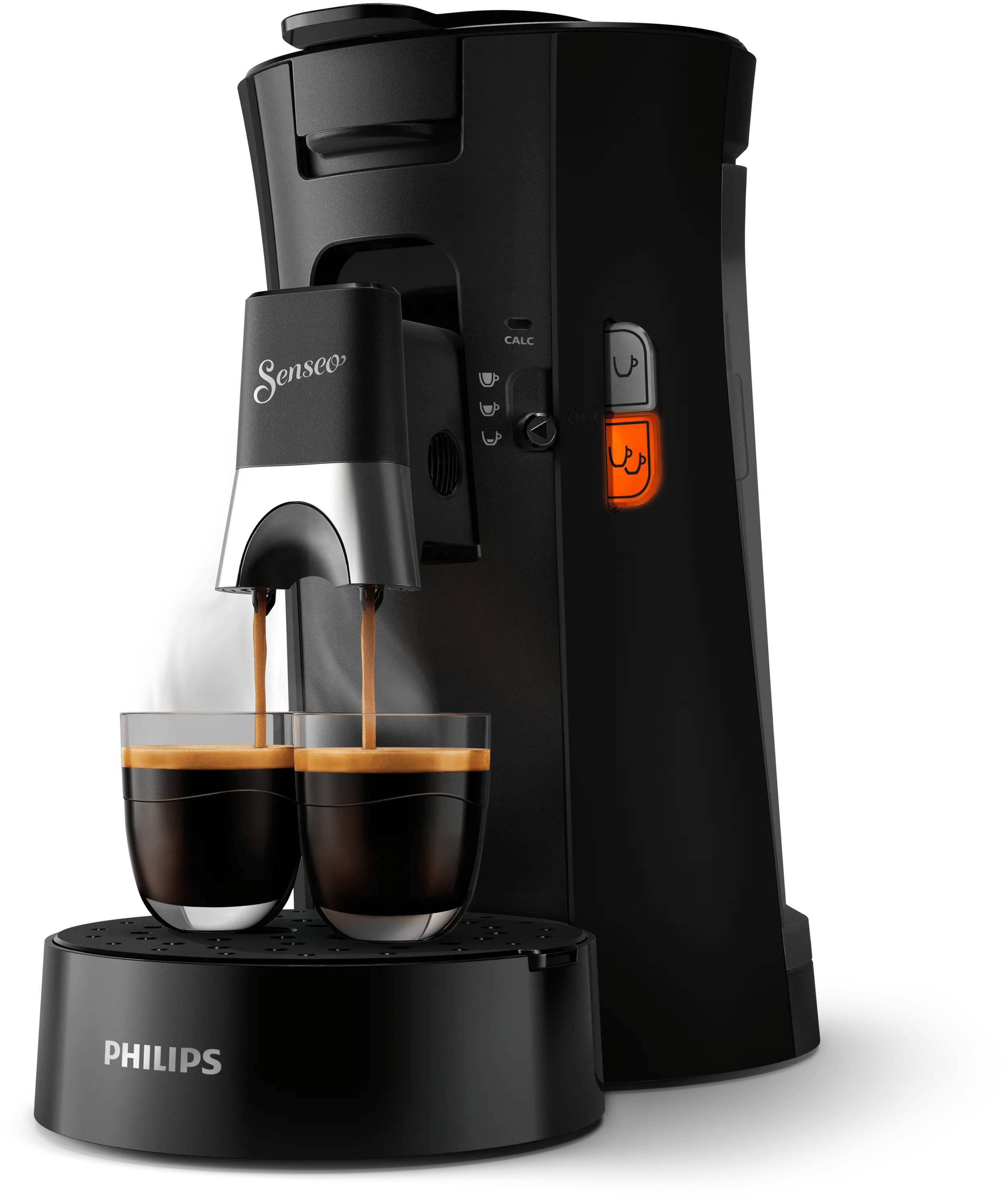 Schwarze Philips Senseo Kaffeemaschine, die Kaffee in zwei Tassen auf einem Abtropfblech ausschenkt, mit beleuchteten Bedienelementen.