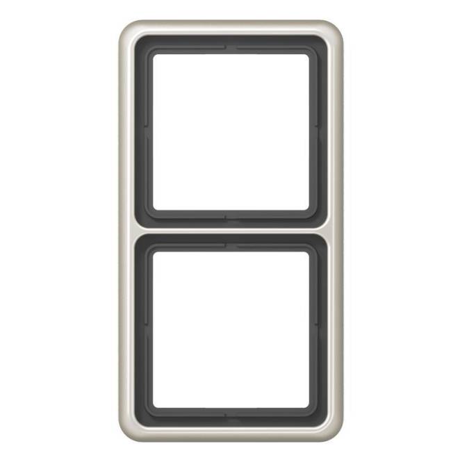 Ein rechteckiger Rahmen mit zwei quadratischen Öffnungen, vertikal übereinander angeordnet, vor einem einfachen Hintergrund.