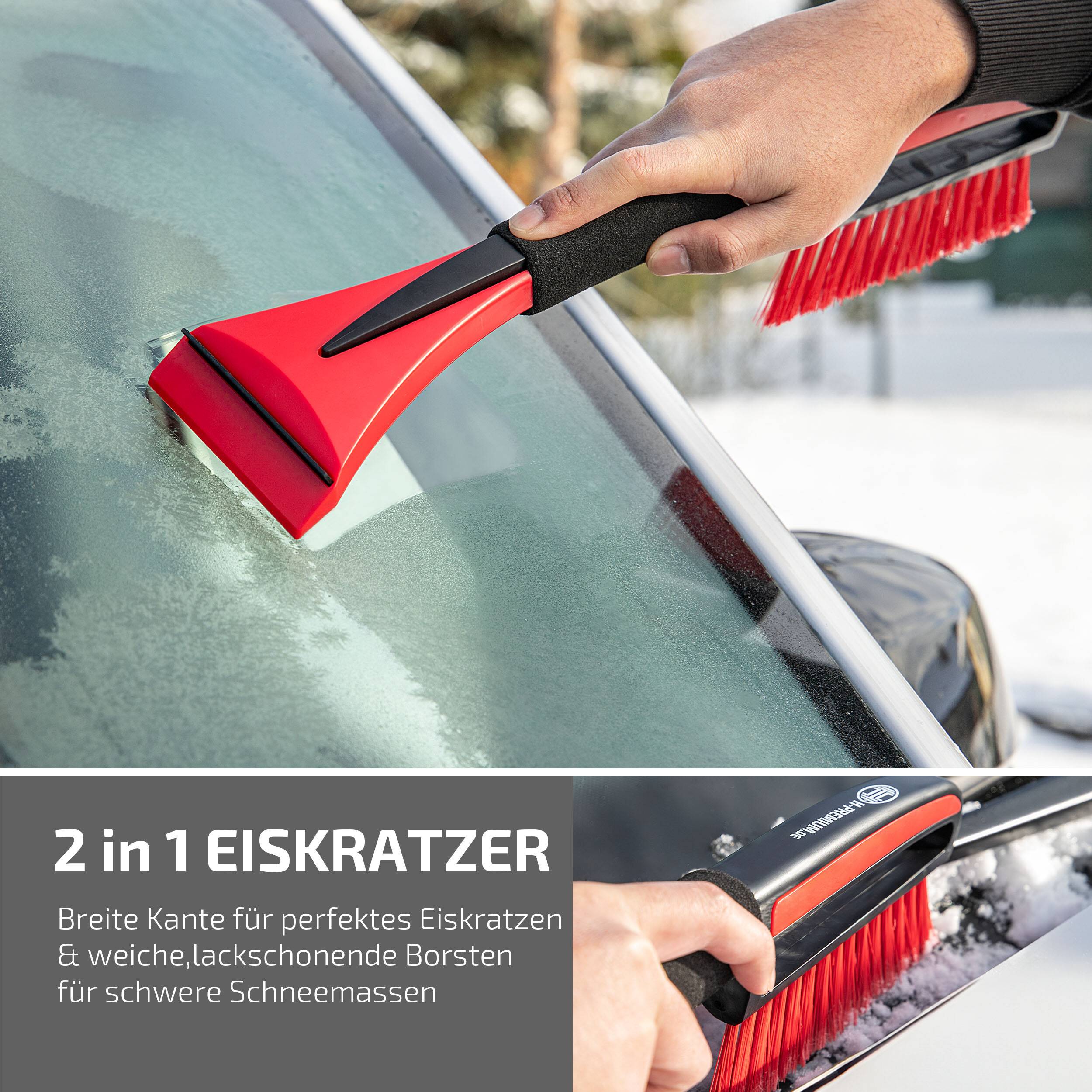Eine Person verwendet einen rot-schwarzen Eiskratzer mit breiter Klinge und weichen Borsten, um Eis von einer Autoscheibe zu entfernen.