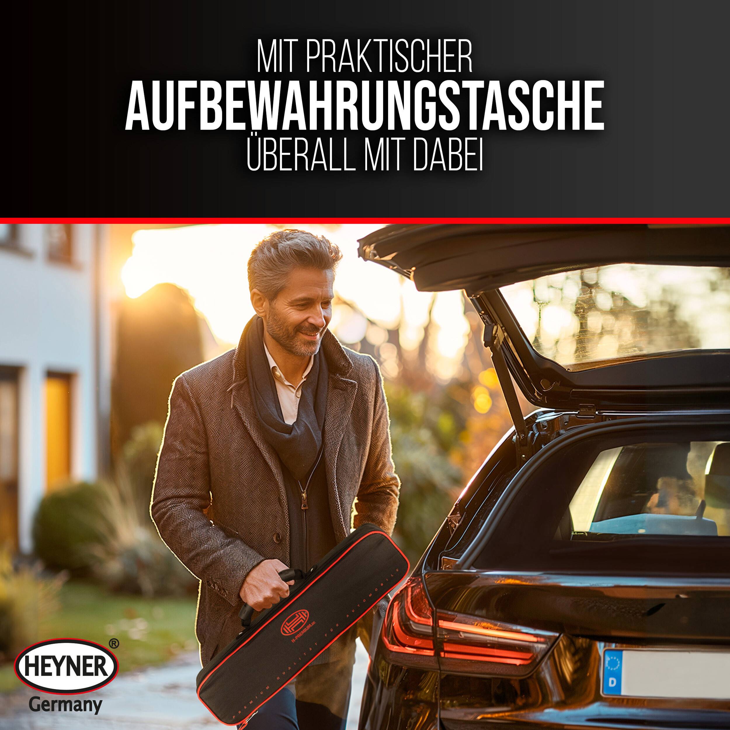 Mann lädt eine schwarze 'HEYNER' Aufbewahrungstasche in den offenen Kofferraum eines Autos; deutscher Anzeigentext lautet 'MIT PRAKTISCHER AUFBEWAHRUNGSTASCHE ÜBERALL MIT DABEI'.