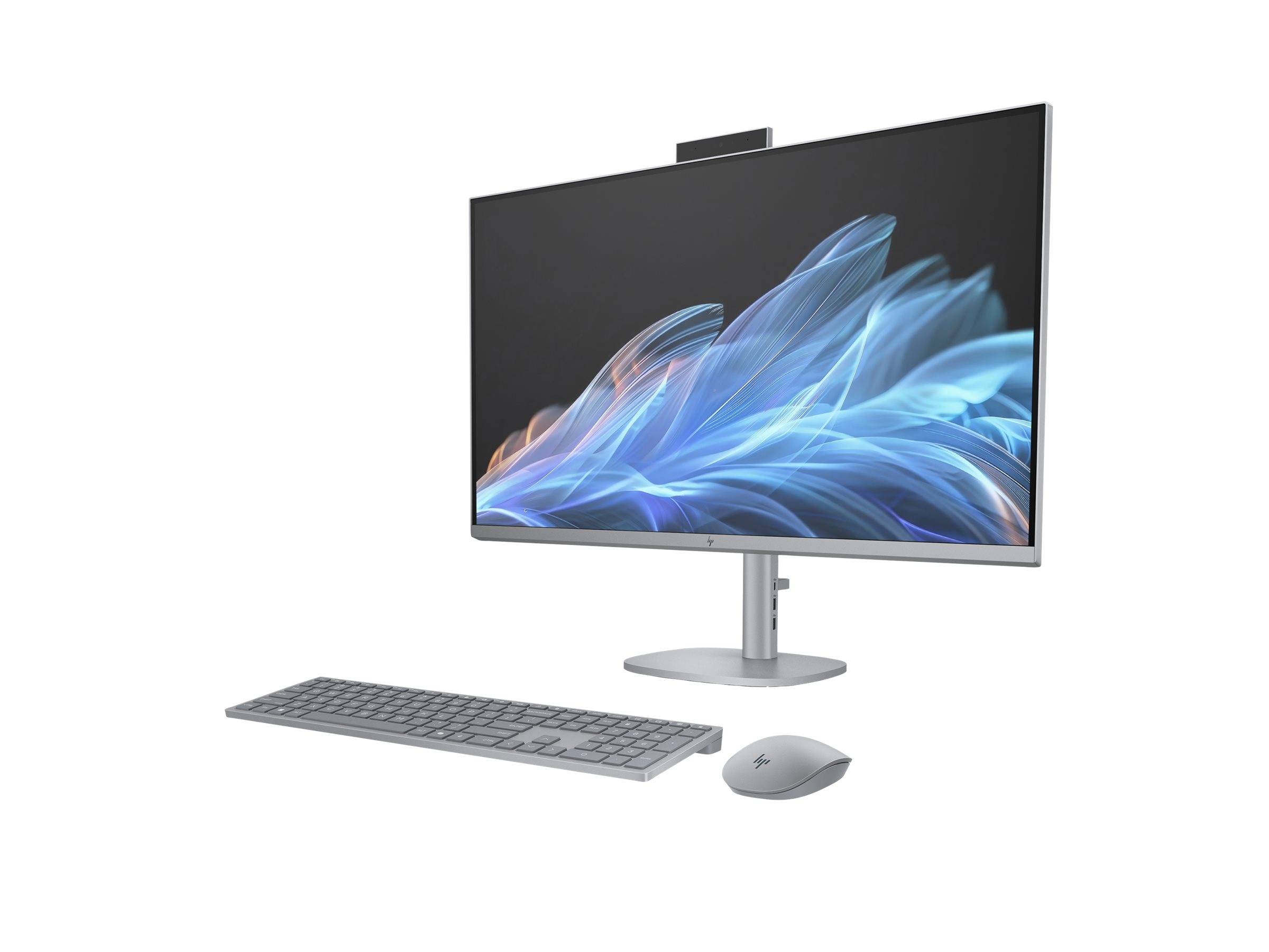 Ein eleganter All-in-One-Computer mit einem schlanken Monitor, auf dem abstrakte blaue Formen angezeigt werden, begleitet von einer minimalistischen grauen Tastatur und Maus.