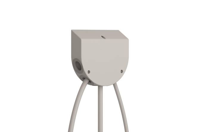 Ein beiges, quadratisches Gerät mit rundem Sockel, das an drei Kabeln befestigt ist. Es hat ein zentrales Belüftungsloch und zwei Seitenlöcher.