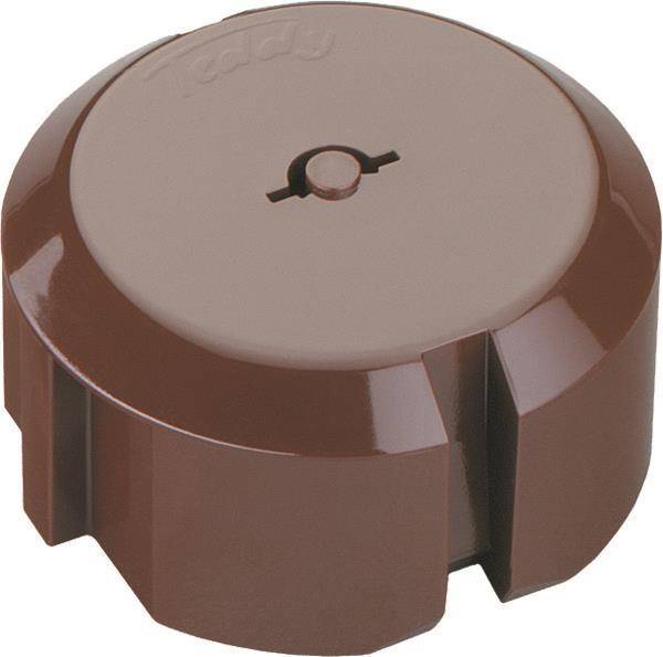 Ein runder, brauner Kunststoffknopf mit einem zentralen Pfeil, der auf eine erhöhte Kerbe zeigt, wird zum Einstellen von Reglern oder Einstellungen auf einem Gerät verwendet.