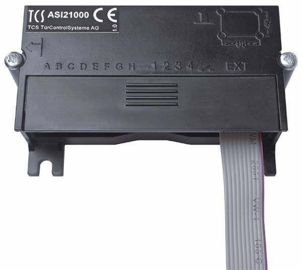 ASI21000 TCS TürControlSysteme AG' Gerät mit beschrifteten Abschnitten 'A B C D E F G H' und '1 2 3 4'. Ein weißes Flachbandkabel ist angebracht.