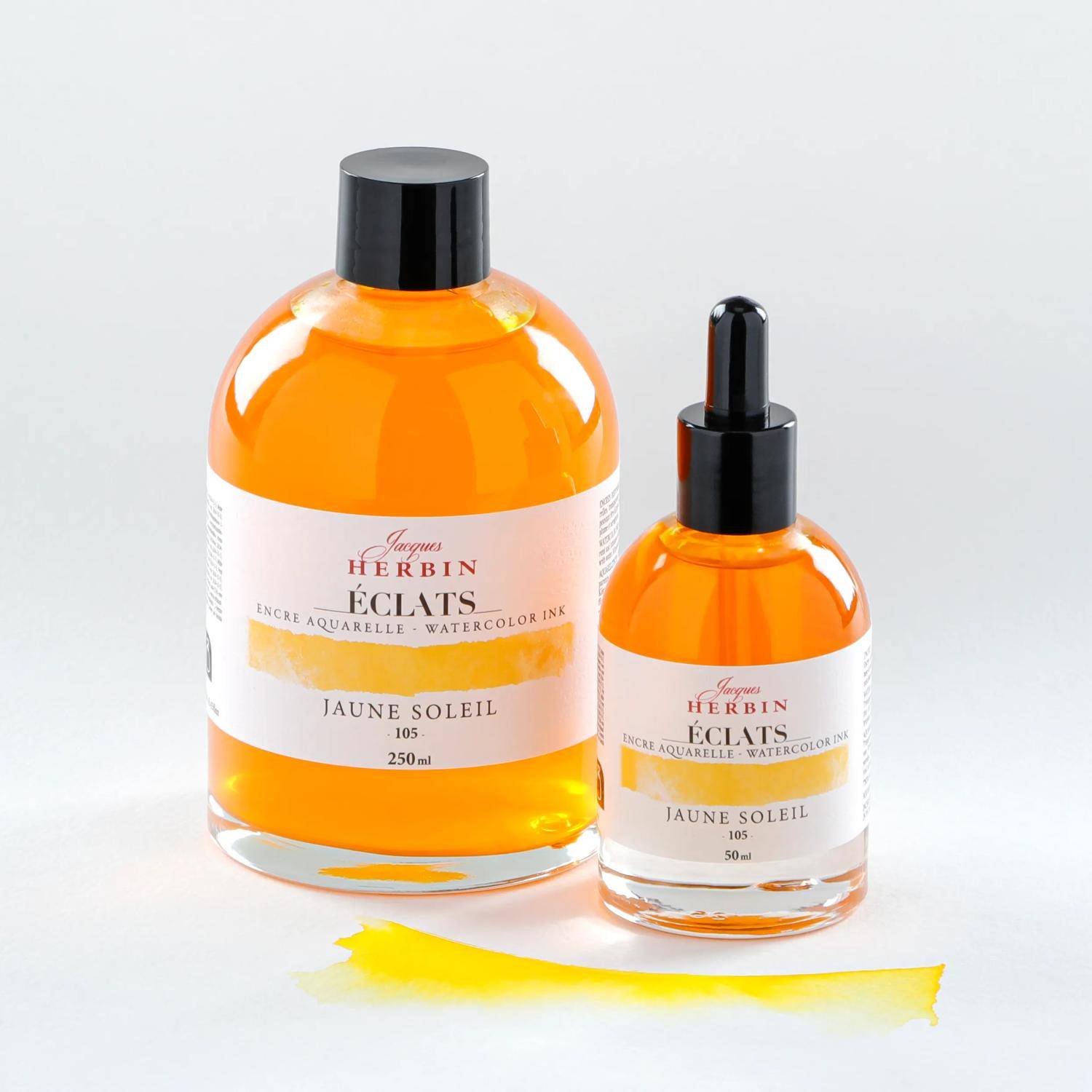 Zwei Flaschen J. Herbin Éclats Aquarelltusche, beschriftet mit 'Jaune Soleil', mit einem gelben Farbmuster daneben.