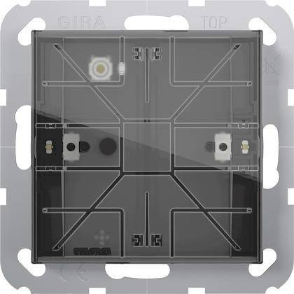 Ein transparentes Gira-Schaltkomponentenelement mit sichtbaren Leiterbahnen und Anschlüssen, entworfen für elektrische Anwendungen.
