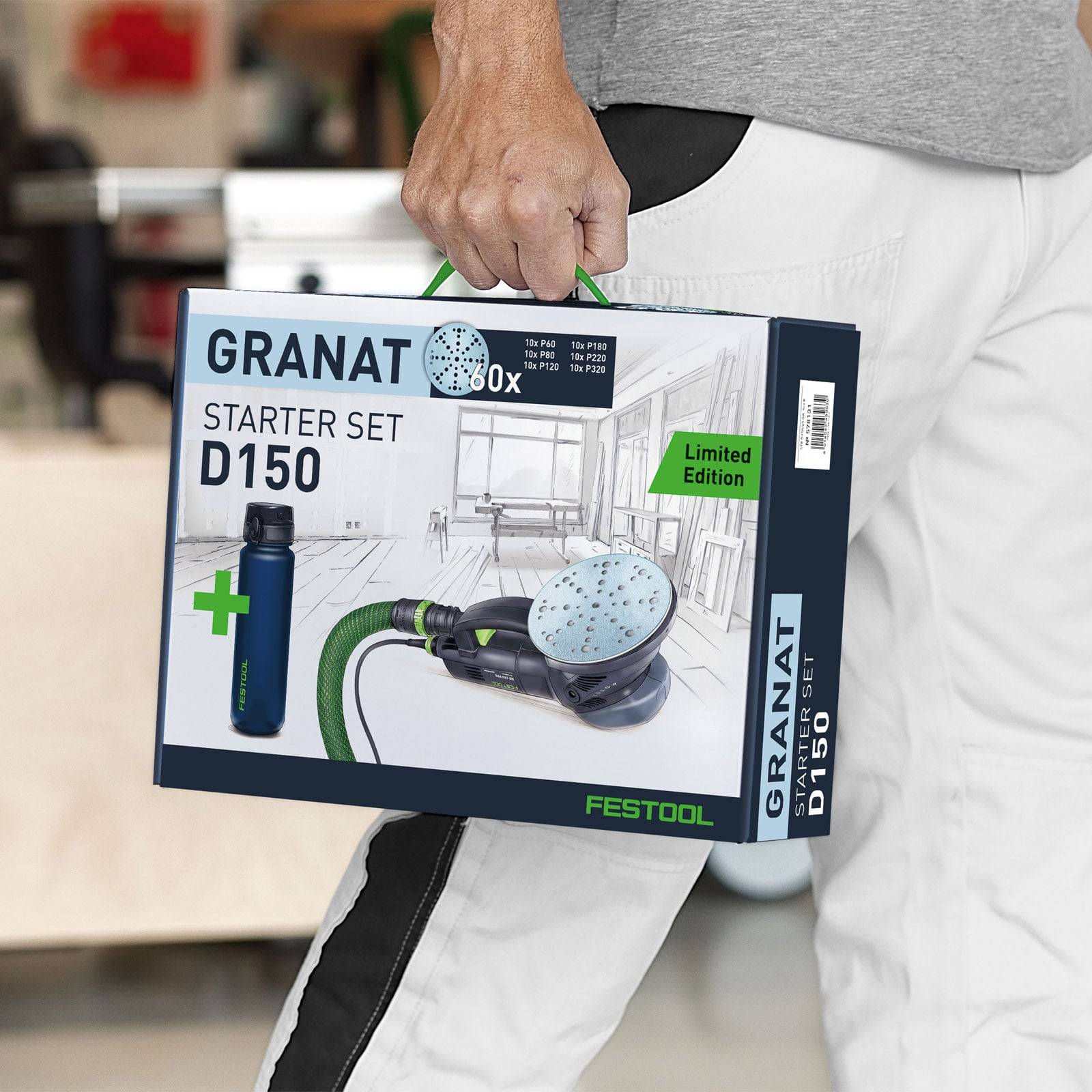 Person hält ein Festool Granat D150 Starter-Set, zeigt ein Schleifgerät und ein 'Limited Edition' Etikett in einer Werkstattumgebung.