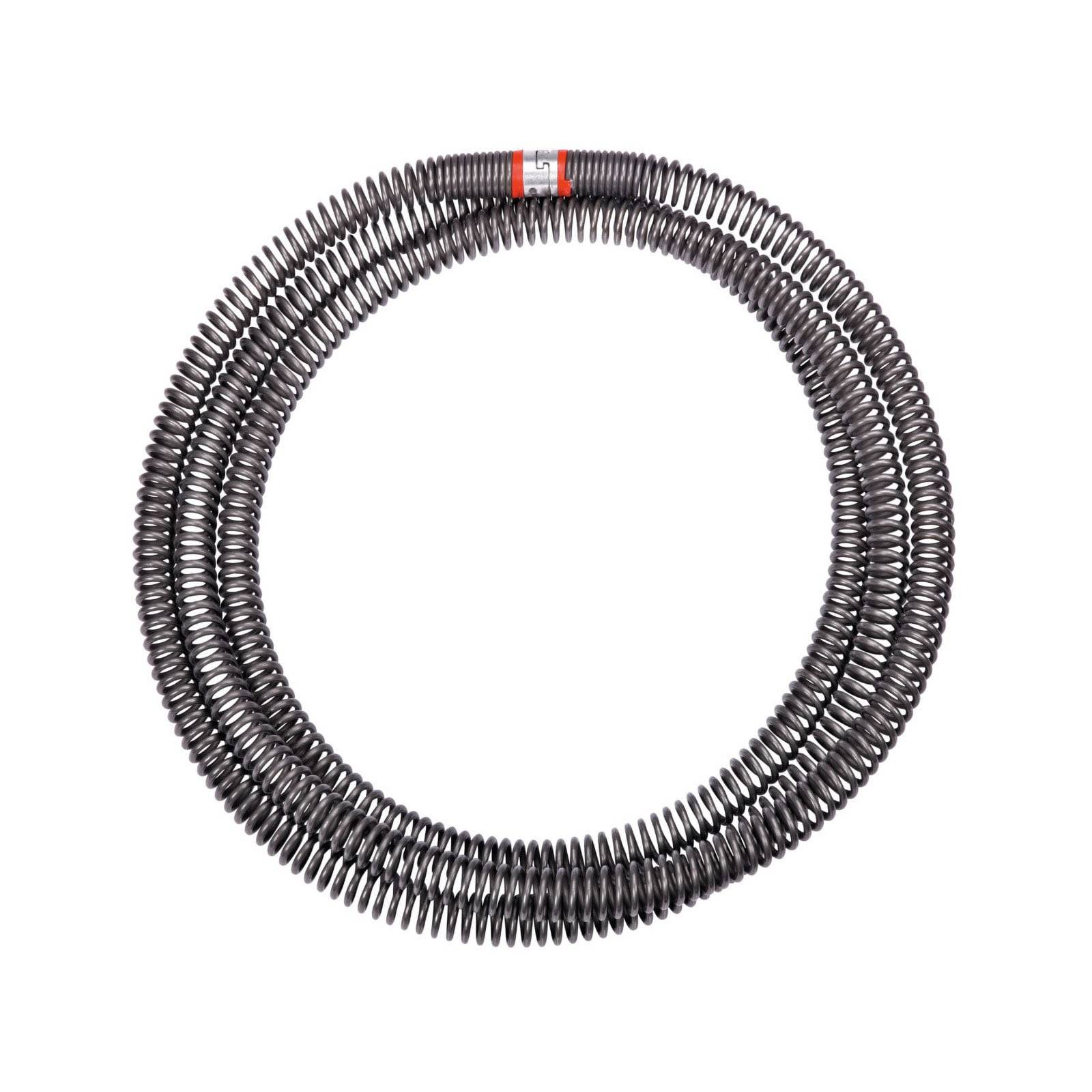 Eine gewickelte Metallspiralfeder, die in einer kreisförmigen Form angeordnet ist, mit einem kleinen roten Etikett an einer Seite.