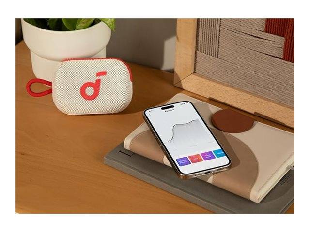 Ein Smartphone auf einem Tisch, das einen Graphen zeigt, neben einem geschlossenen rosa-weißen kabellosen Ohrhörerset-Etui.