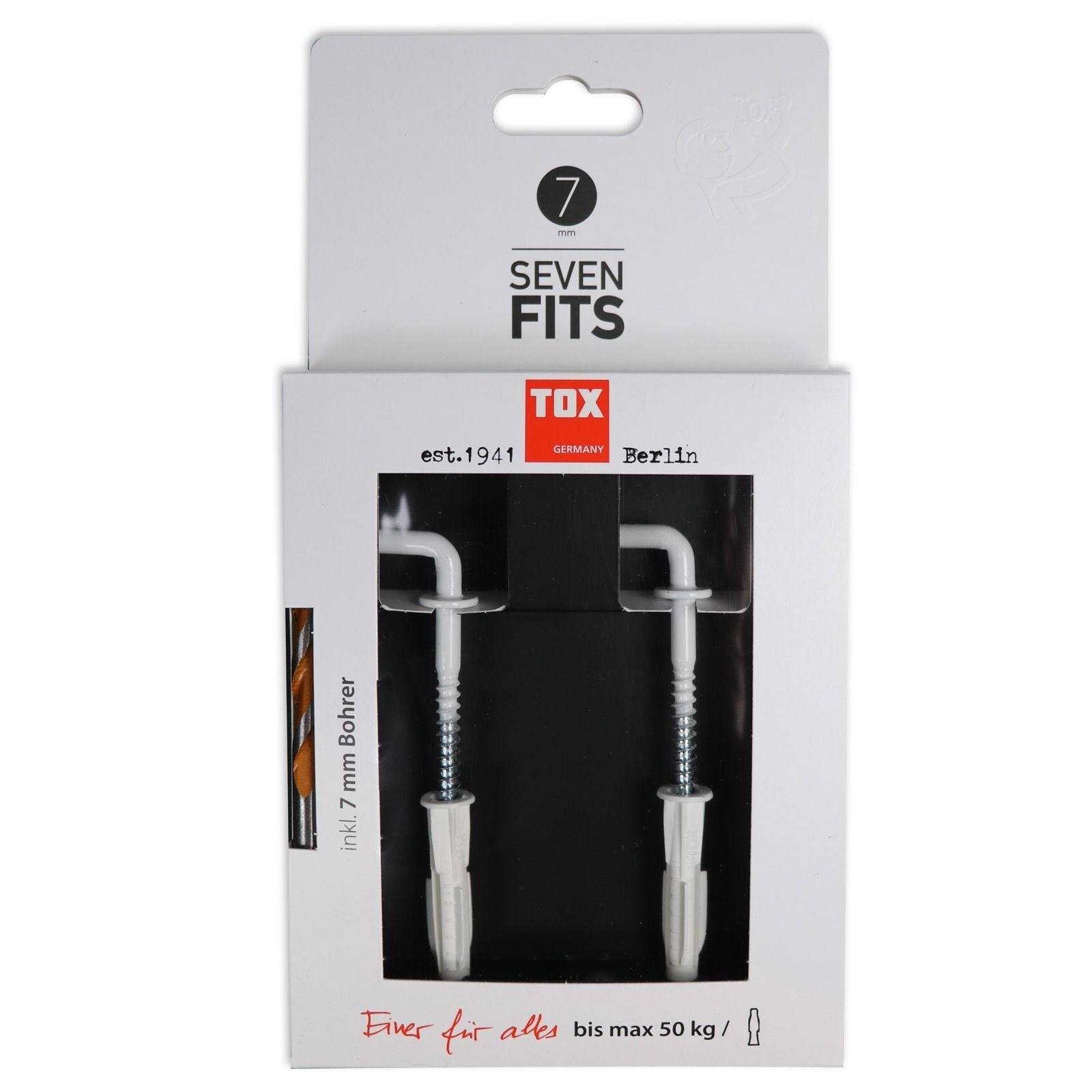 Packung für TOX Deutschland 'Seven Fits' Wanddübel, enthält zwei Metalldübel mit Schrauben. Text erwähnt 'seit 1941 Berlin' und Gewichtslimit 'bis max 50 kg'.