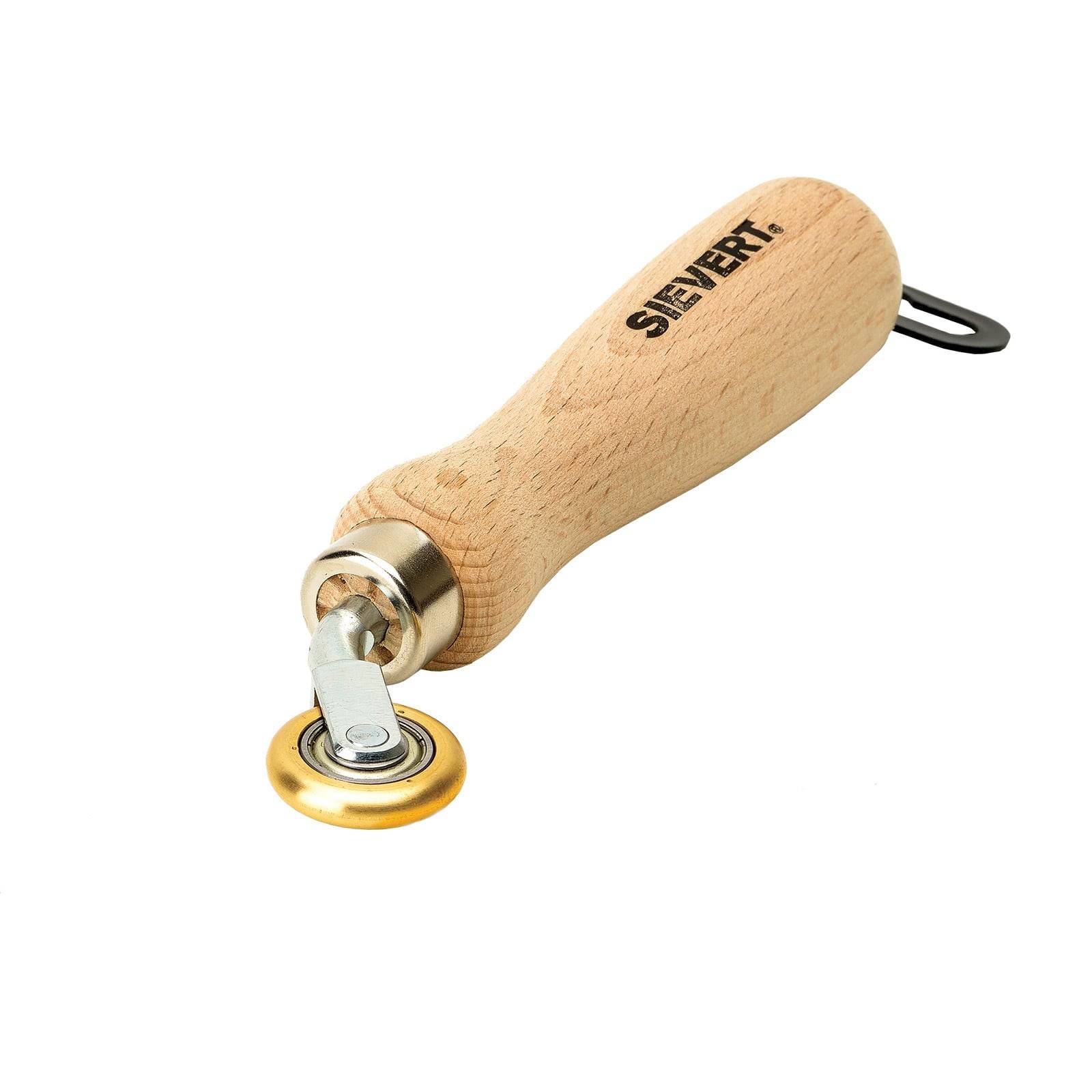 Ein Rollsaumer mit Holzgriff und Messingwalze, verwendet zum Andrücken von Nähten, mit dem Markennamen 'SIEVERT', der auf dem Griff aufgedruckt ist.