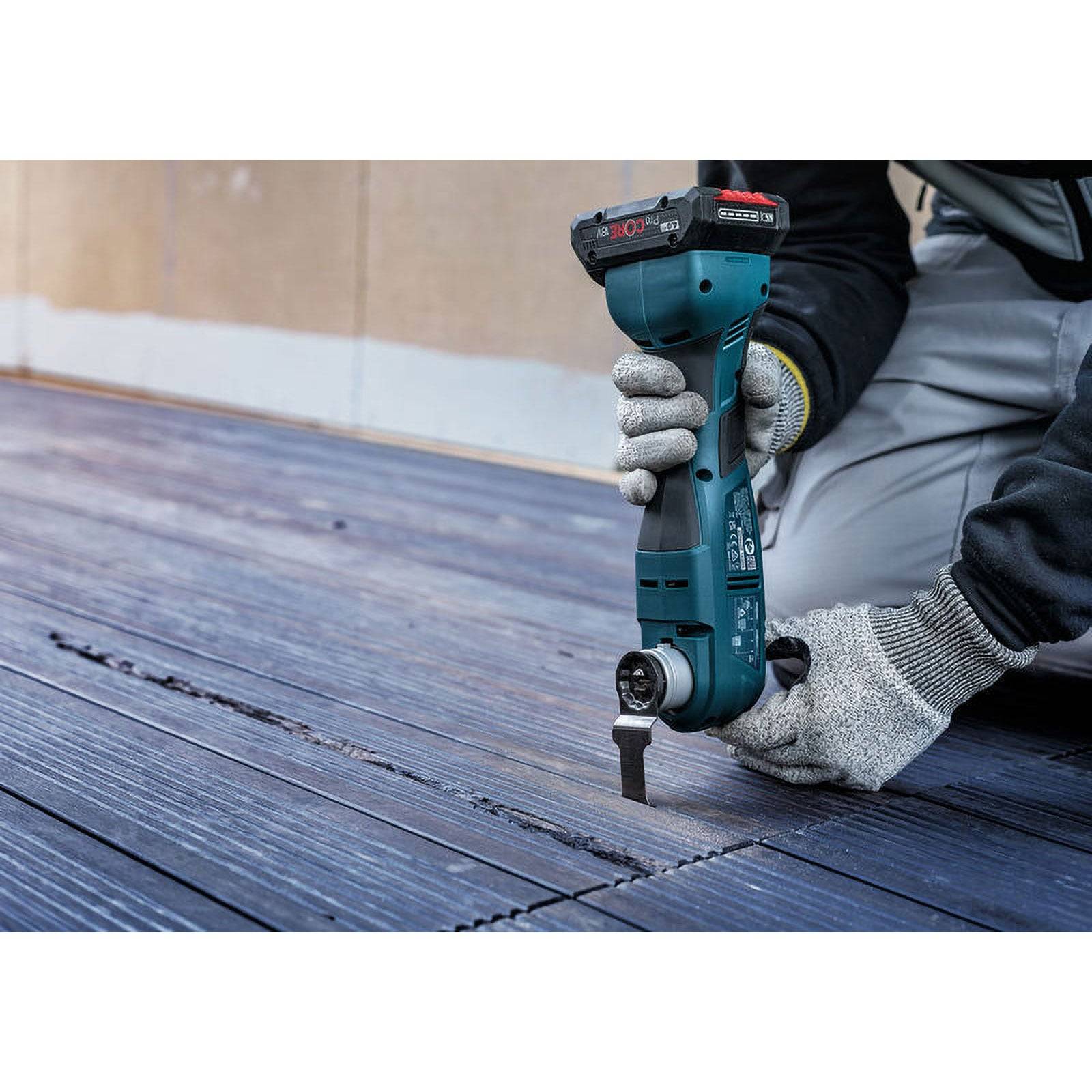 Eine Person mit Handschuhen verwendet ein blaues Elektrowerkzeug, um in eine Holzoberfläche zu bohren, wobei der Fokus auf Präzision und Sicherheit liegt.