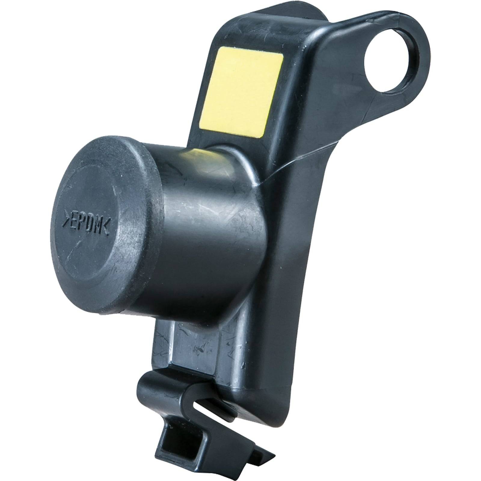 Eine schwarze Gummidurchführung oder Kabeldurchführung mit einer Schlaufe und einem Etikett, die zur sicheren Kabel- oder Leitungsführung in Maschinen oder elektrischen Installationen verwendet wird.