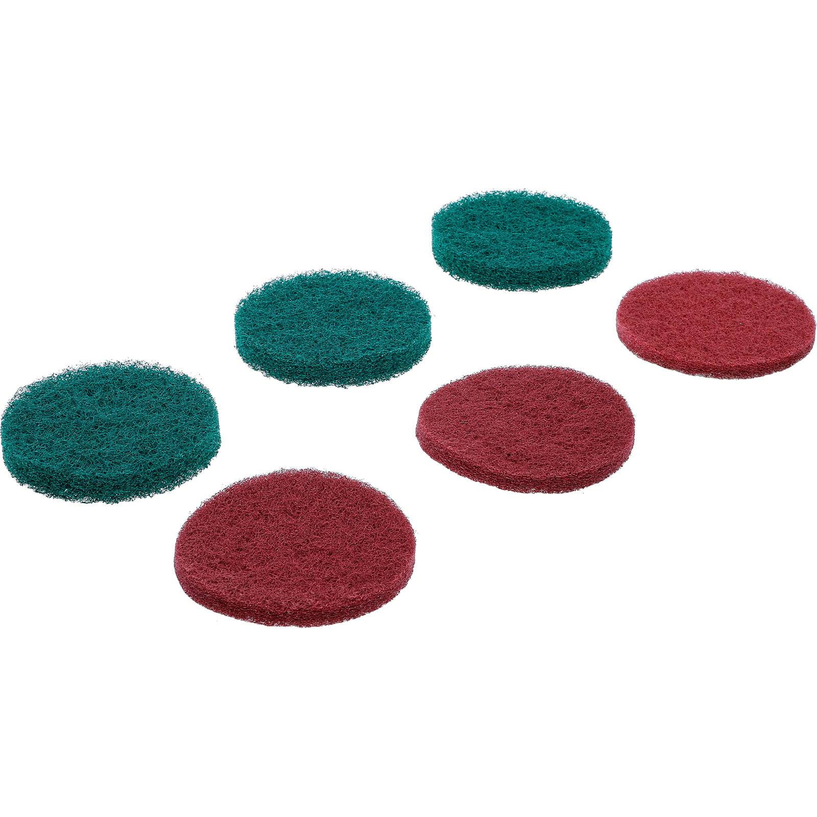Ein Satz von sechs kreisförmigen Reinigungspads, drei rot und drei grün, in zwei Reihen angeordnet. Jeder Pad hat eine strukturierte Oberfläche zum Reinigen.