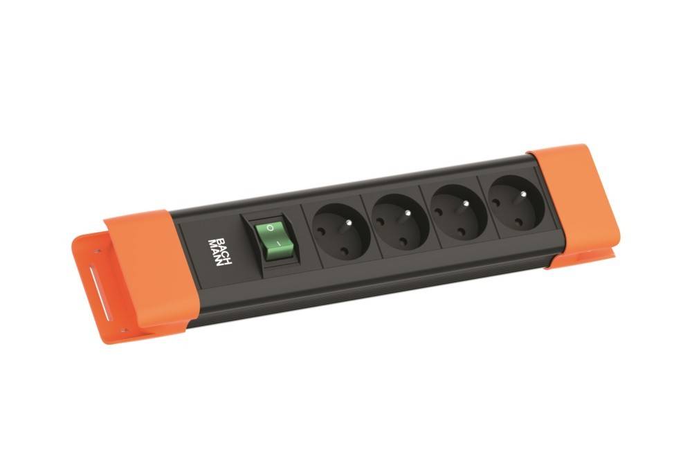Ein schwarzer Überspannungsschutz mit vier europäischen Steckdosen und einem grünen Schalter, gerahmt von orangefarbenen Enden.