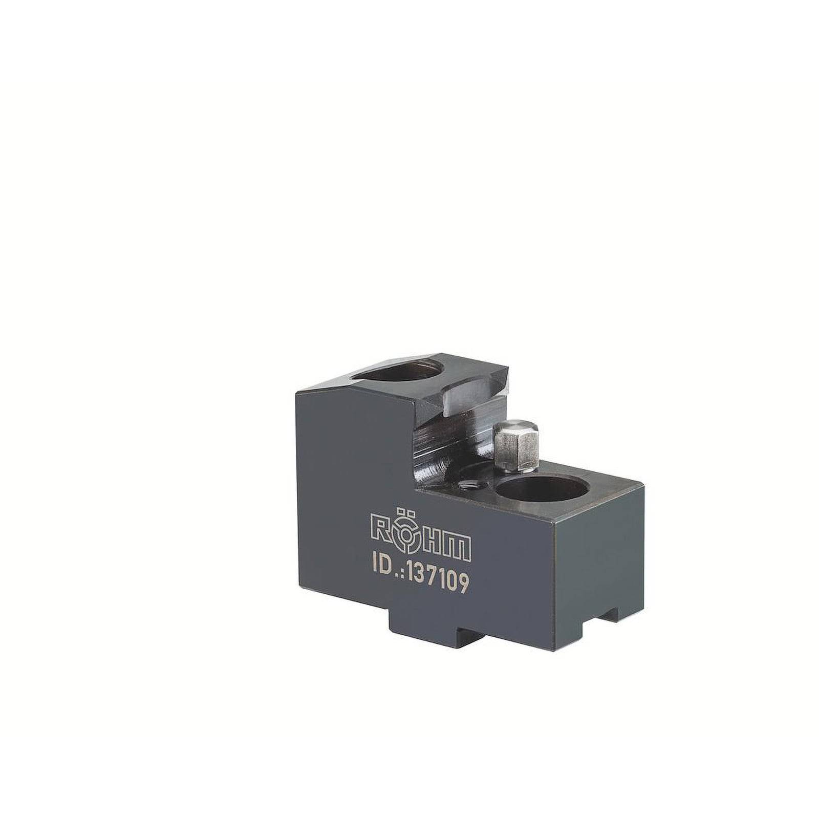 Ein Metallteil mit Löchern und einem Bolzen, gekennzeichnet mit 'RÖHM ID.137109', möglicherweise eine Maschinenkomponente oder ein Zubehör.