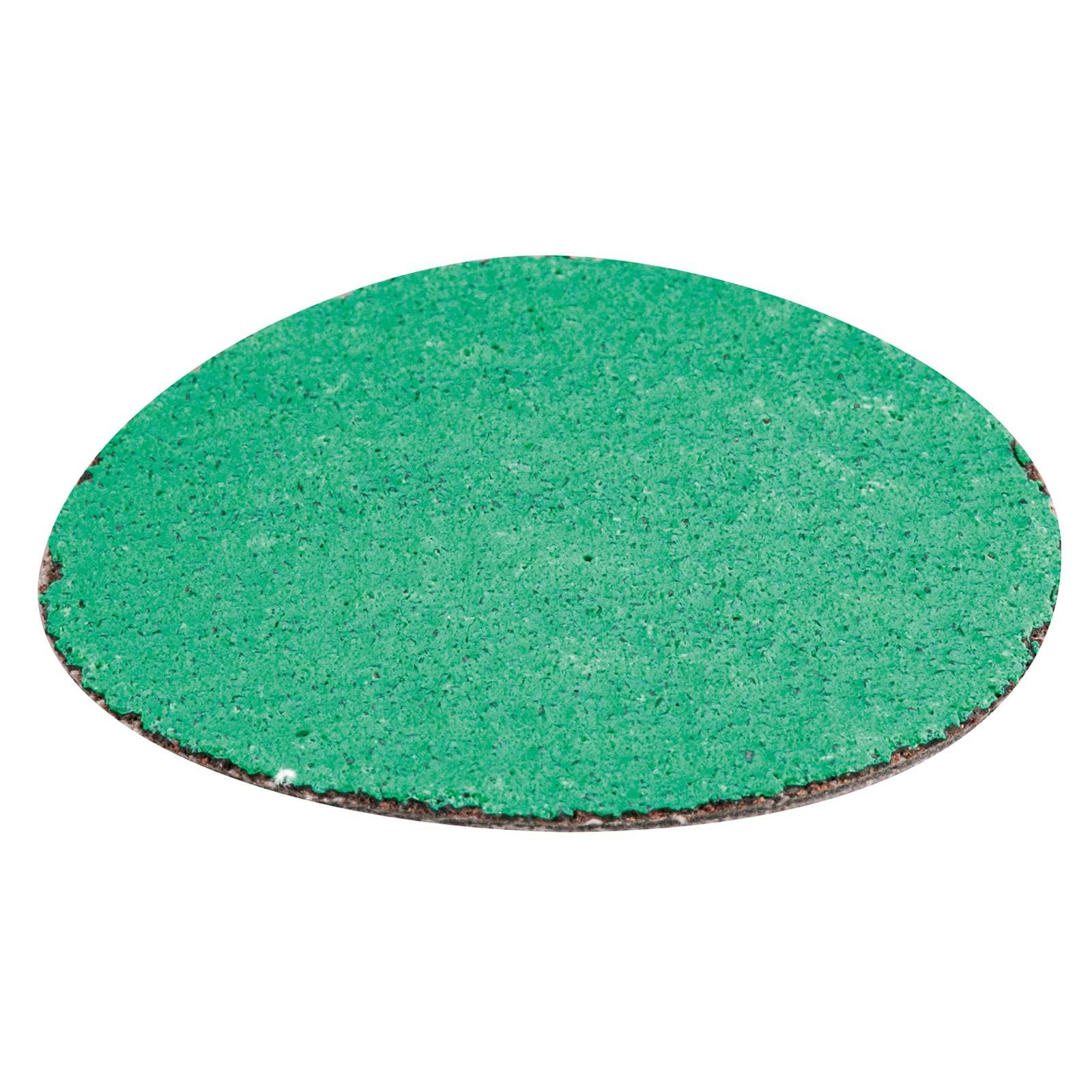 Eine grüne kreisförmige Scheibe, höchstwahrscheinlich ein Stück Schleifpapier, mit einer rauen Textur und einem dünnen, abgenutzten Rand.