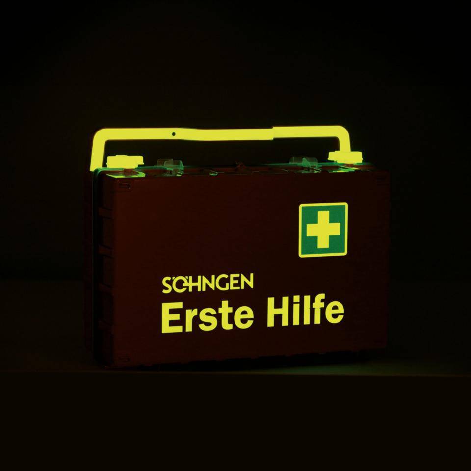 SÖHNGEN® Erste-Hilfe-Koffer DYNAMIC-GLOW L, DIN 13169, orange, inkl. Wandhalterung