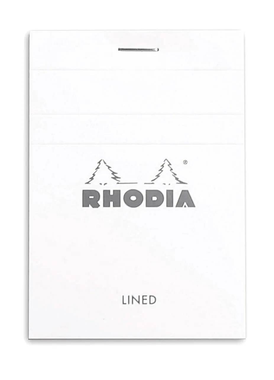 Weiß kariertes Rhodia-Notizbuch mit spiralgebundener Oberseite und dem RHODIA-Logo mittig über dem Wort „KARIERT