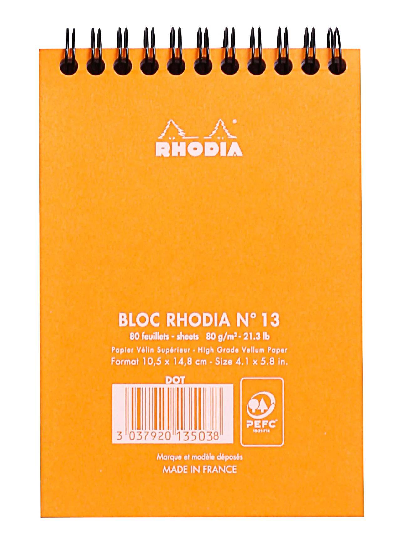 Das Bild zeigt die Vorderseite eines orangefarbenen Rhodia-Notizbuchs, Modell Nr. 13, mit einer Größe von 10,5 x 14,8 cm und einem Umfang von 80 Blättern.
