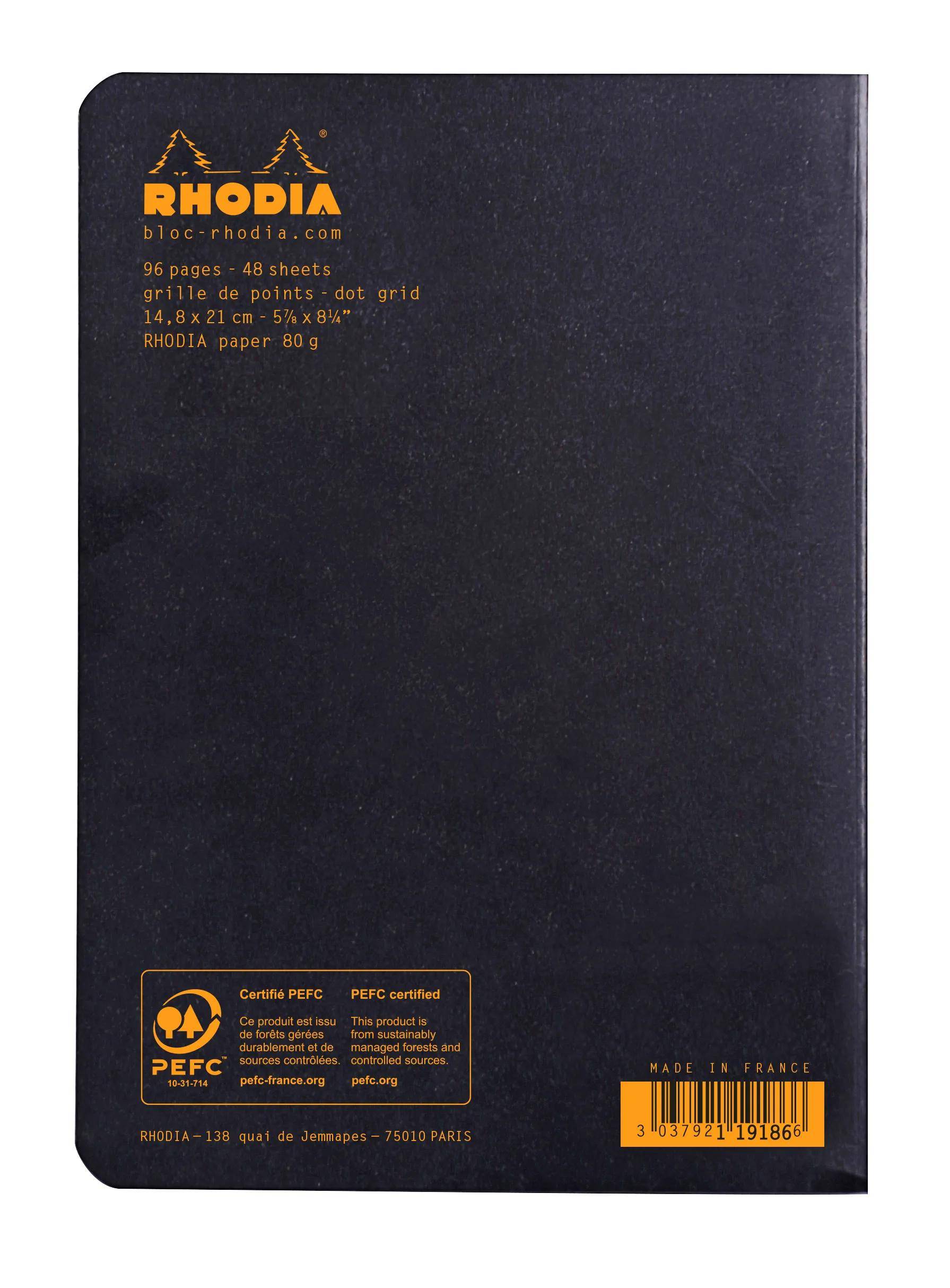 Schwarzes Rhodia-Notizbuch mit Punktraster auf dem Umschlag, schwarz mit orangefarbener 'RHODIA'-Branding, PEFC-Zertifizierungsetikett und Barcode.