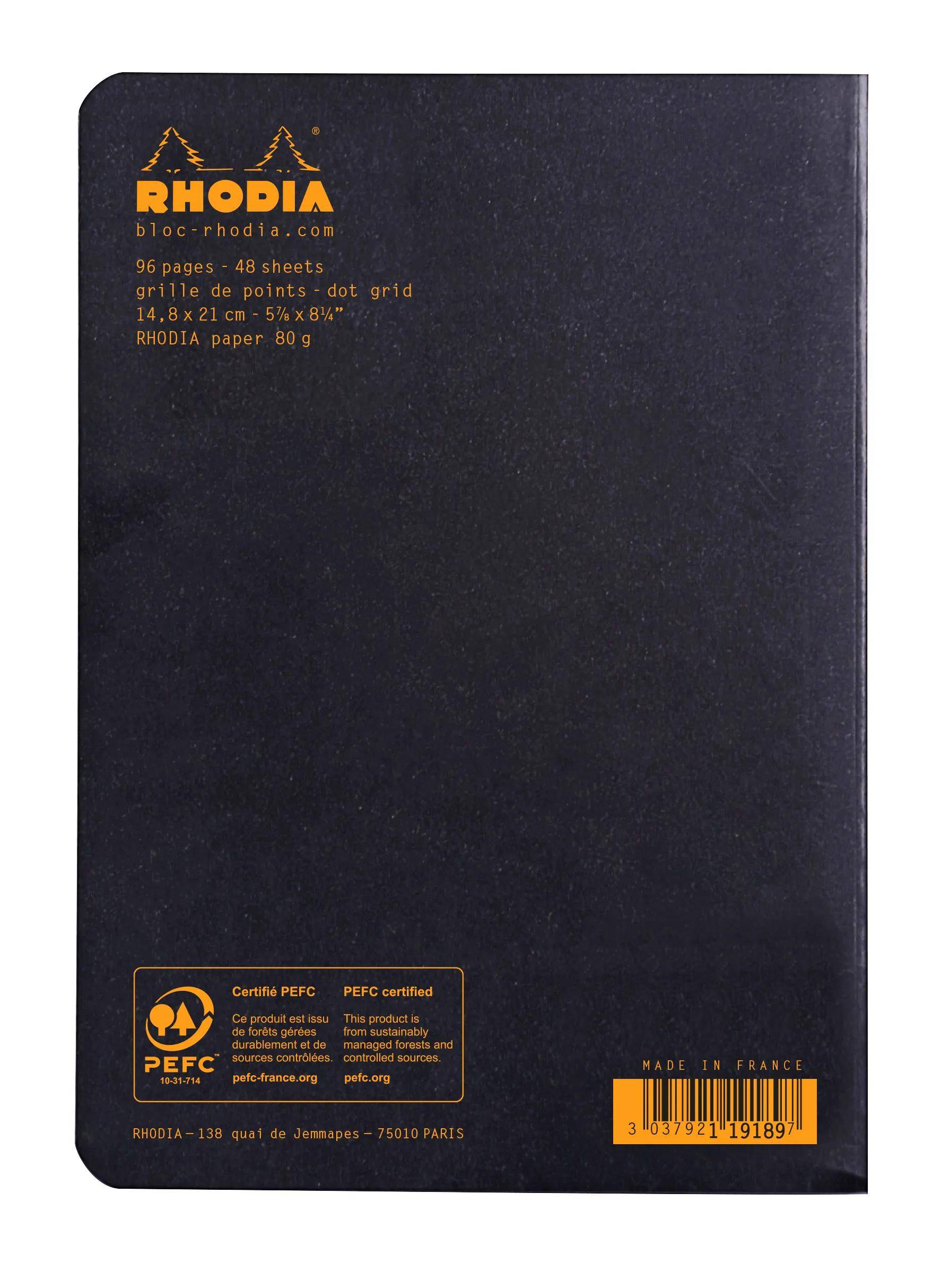 Schwarzer Rhodia-Notizbucheinband mit orangenem Logo und Text, Punktraster-Details, PEFC-Zertifizierung und Made-in-France-Etikett.
