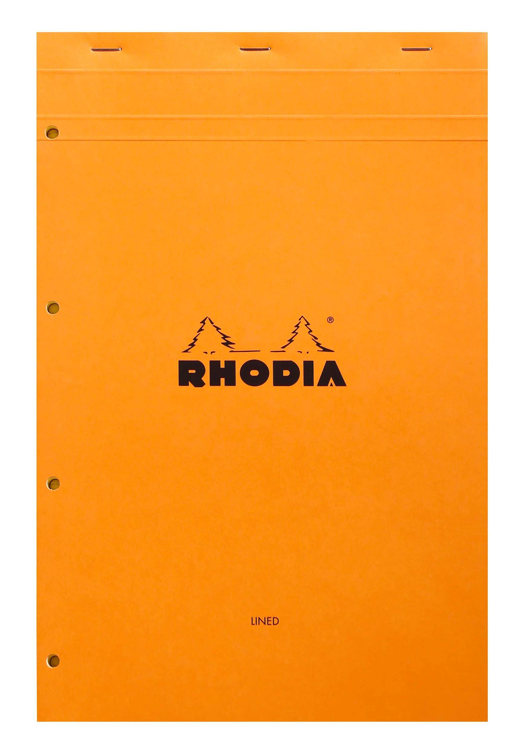 Rhodia'-Notizbuch mit orangefarbenem Umschlag, das das Rhodia-Logo mit zwei Kiefern zeigt. Der Umschlag ist liniert, was wahrscheinlich auf linierte Seiten im Inneren hindeutet.