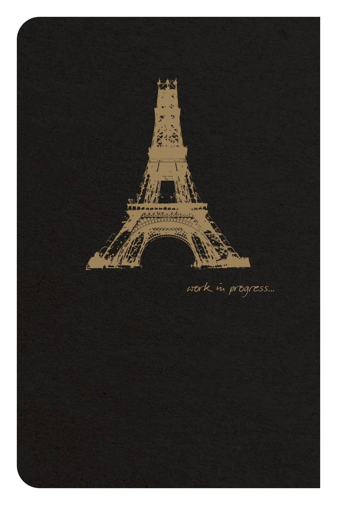Schwarzer Notizbucheinband mit einem beige skizzierten Eiffelturm und dem Text „work in progress...
