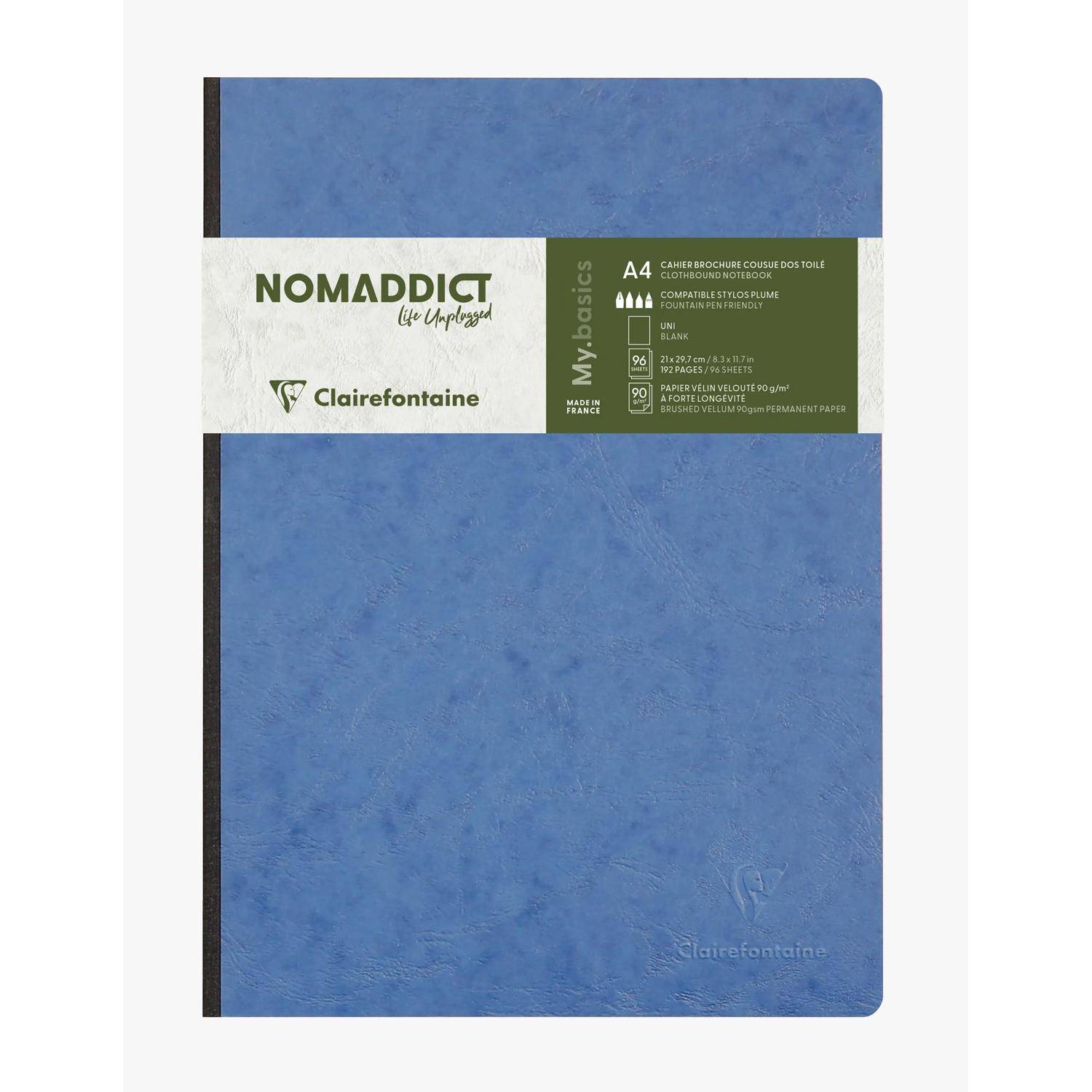 Blaues Clairefontaine NOMADDICT A4-Notizbuch mit liniertem Papier, schwarzem Rücken und weiß-grünem Papierband-Etikett.