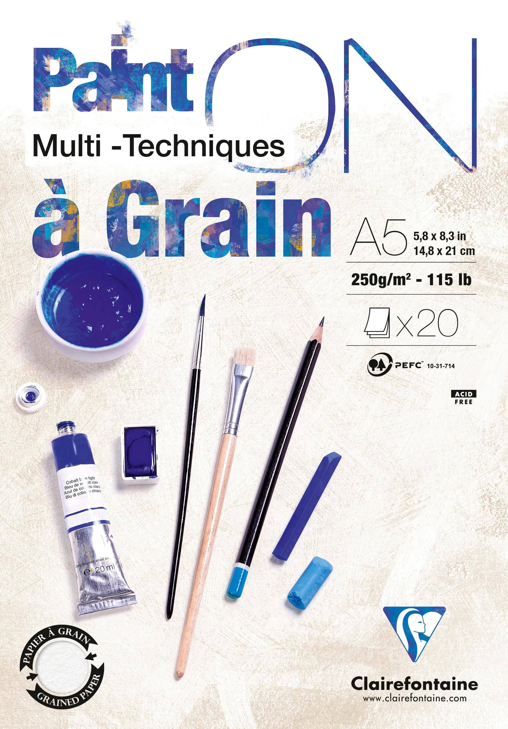 Clairefontaine 'Paint on' A5 Multitechniken-Kunstpapiblock, 250 g/m², 20 Blatt, gezeigt mit Farbe, Pinseln und Zeichenwerkzeugen.