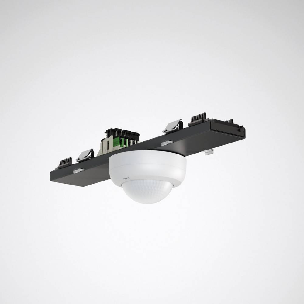 Ein weißer, kuppelförmiger Sensor, der auf einer schwarzen rechteckigen Basis montiert ist und wahrscheinlich zur Erkennung von Bewegung oder Anwesenheit in einem Raum dient.