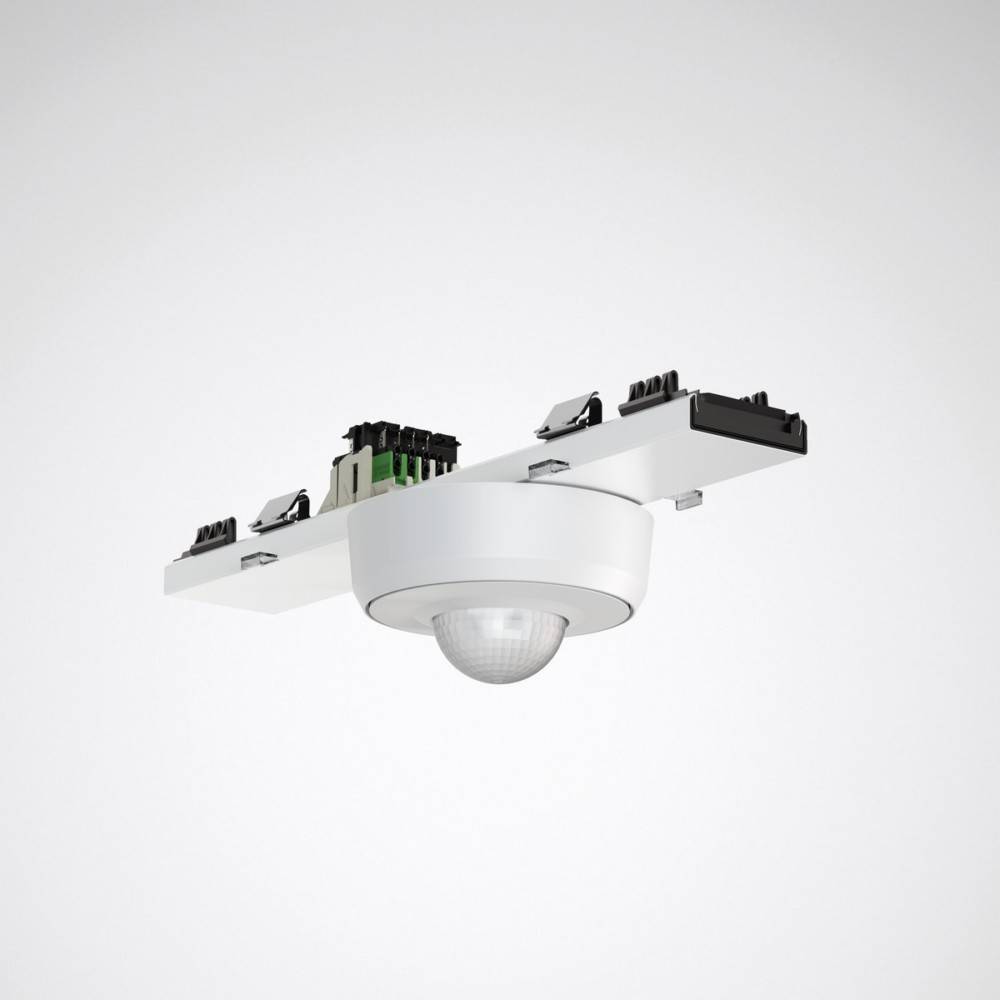 Ein weißer Bewegungsmelder mit einer kugelförmigen Basis, der auf einer horizontalen Oberfläche montiert ist und mehrere Anschlüsse und elektronische Komponenten auf der Oberseite aufweist.