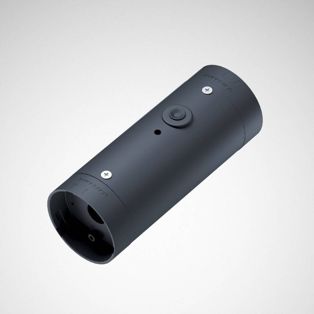 Eine zylindrische schwarze Kamera mit Objektiv, kleinem Knopf und minimalistischem Design, die vor einem hellgrauen Hintergrund präsentiert wird.